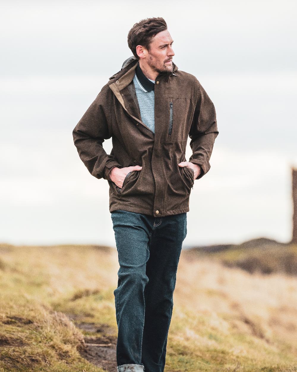 Dark Green coloured Hoggs of Fife Struther Waterproof Lightweight Jacket on mountain background 