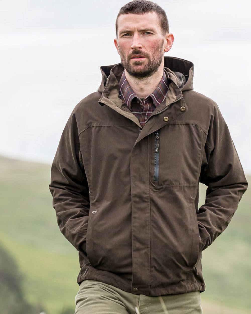 Dark Green coloured Hoggs of Fife Struther Waterproof Lightweight Jacket on sky background 