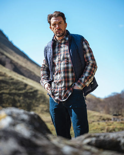 Rust Olive Navy coloured Hoggs of Fife Tiree Herringbone Check Shirt on mountain background 