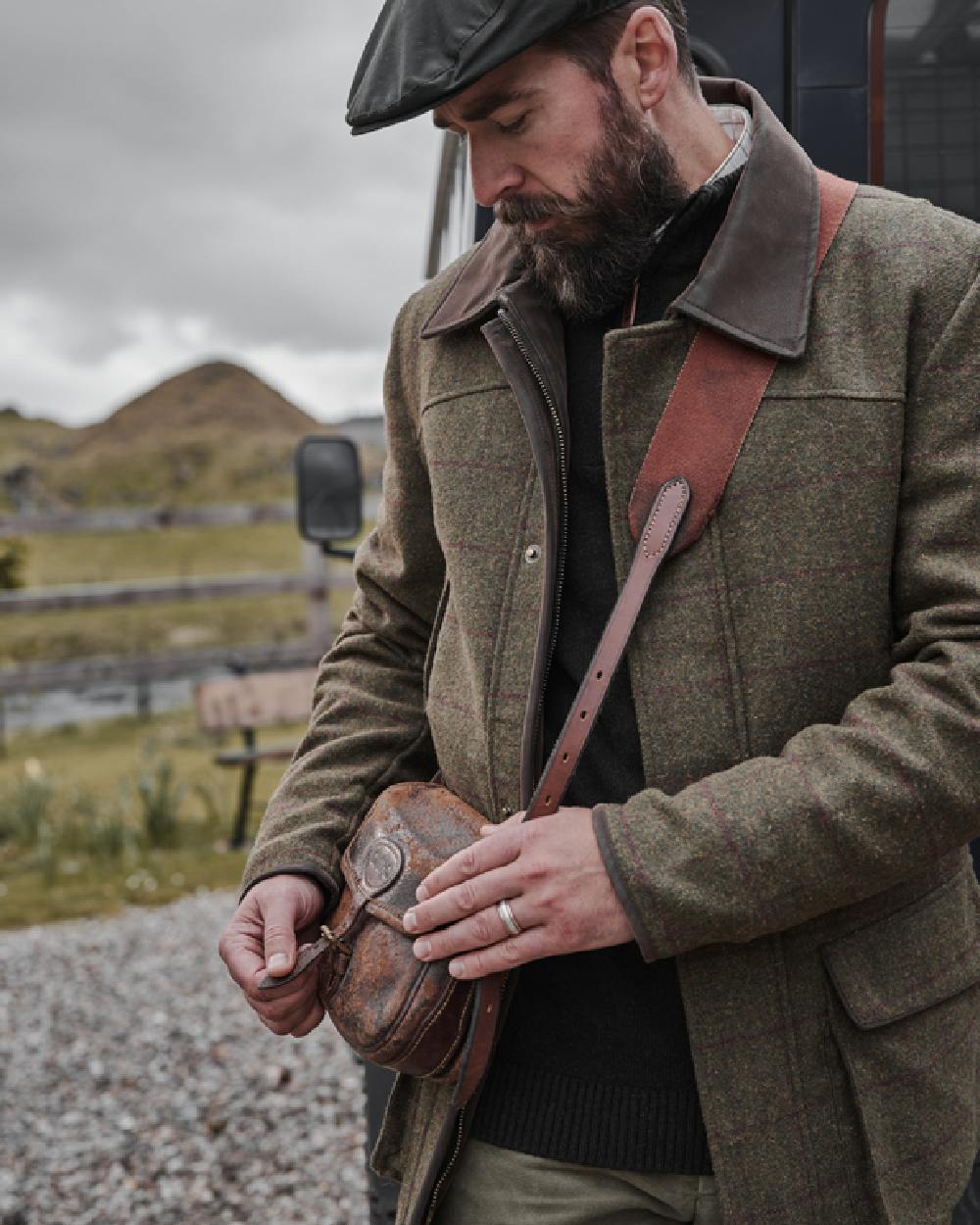 Olive Wine Coloured Hoggs of Fife Tummel Tweed Field Coat on mountain background 