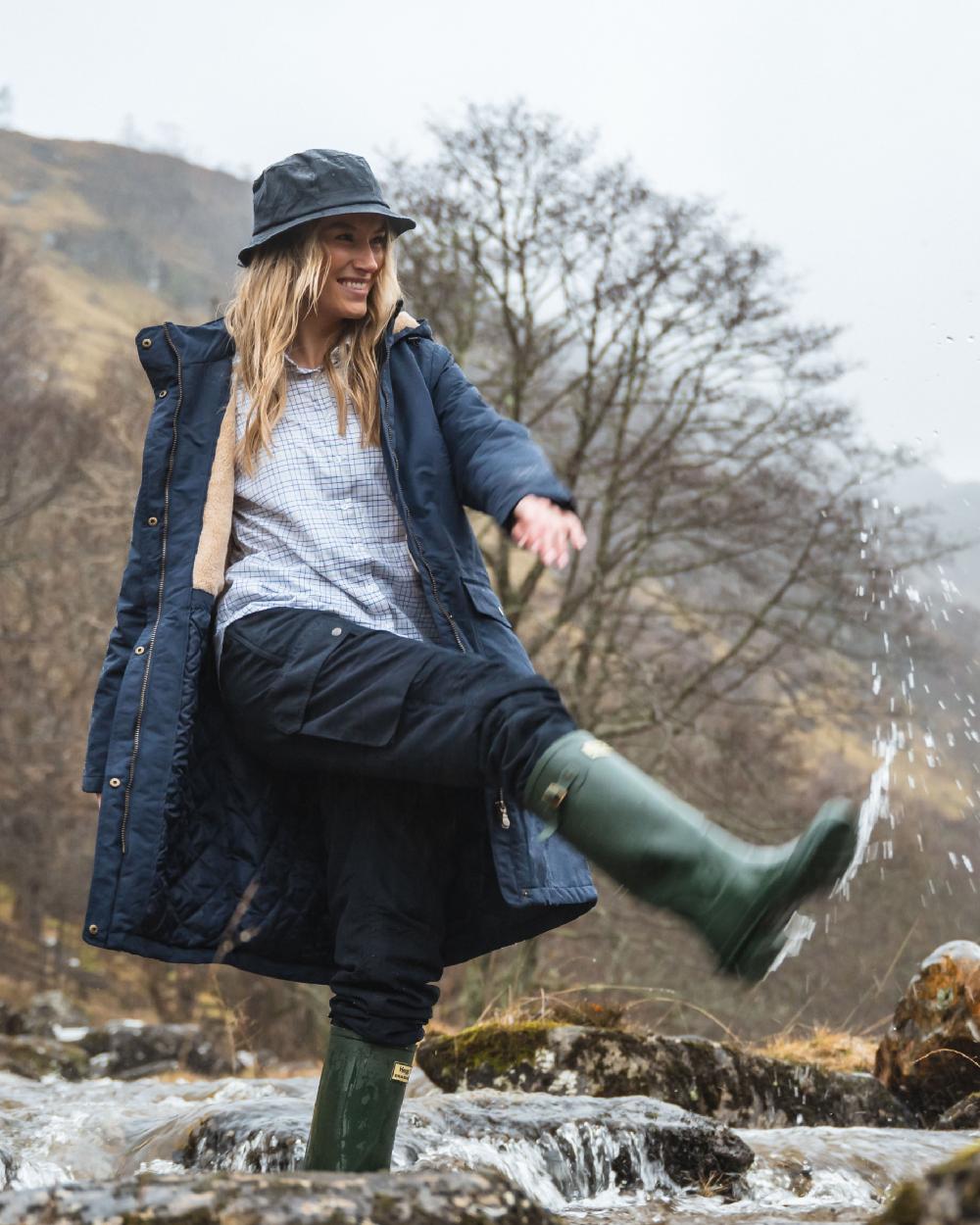 Navy Coloured Hoggs of Fife Waxed Bush Hat on forest background 