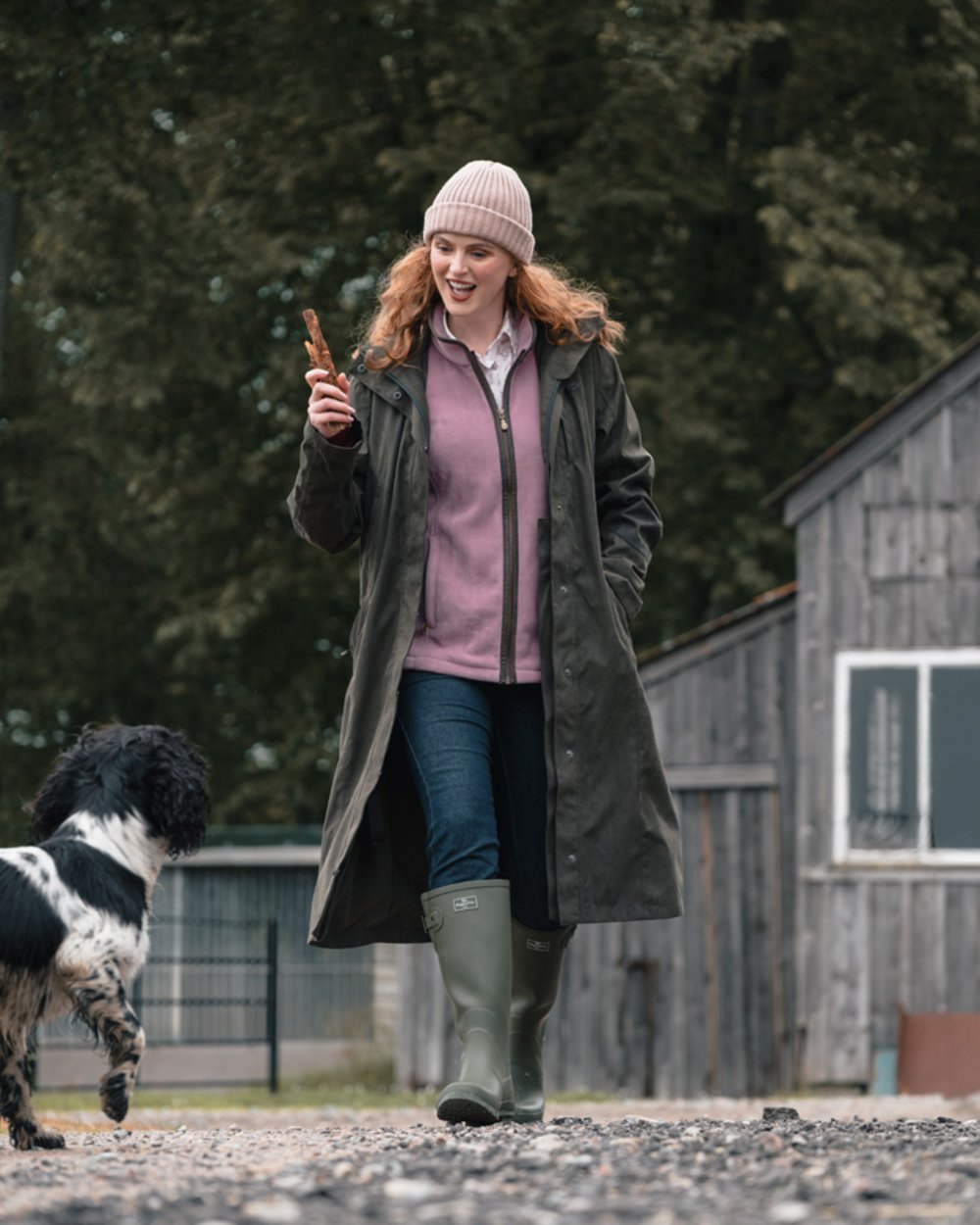 Dark Olive coloured Hoggs of Fife Womens Ardross Pro Long Riding Coat on farm background 
