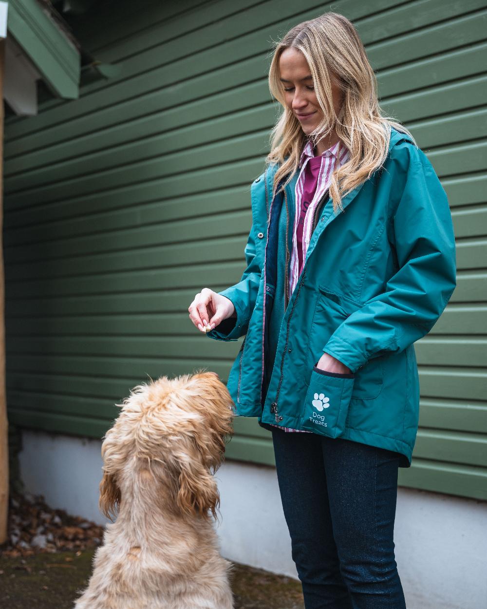 Teal Coloured Hoggs of Fife Womens Fara Waterproof Jacket on countryside background 