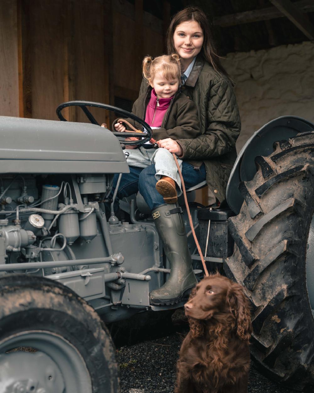 Forest Green Coloured Hoggs of Fife Womens Ladybank Quilted Jacket on outdoor background 