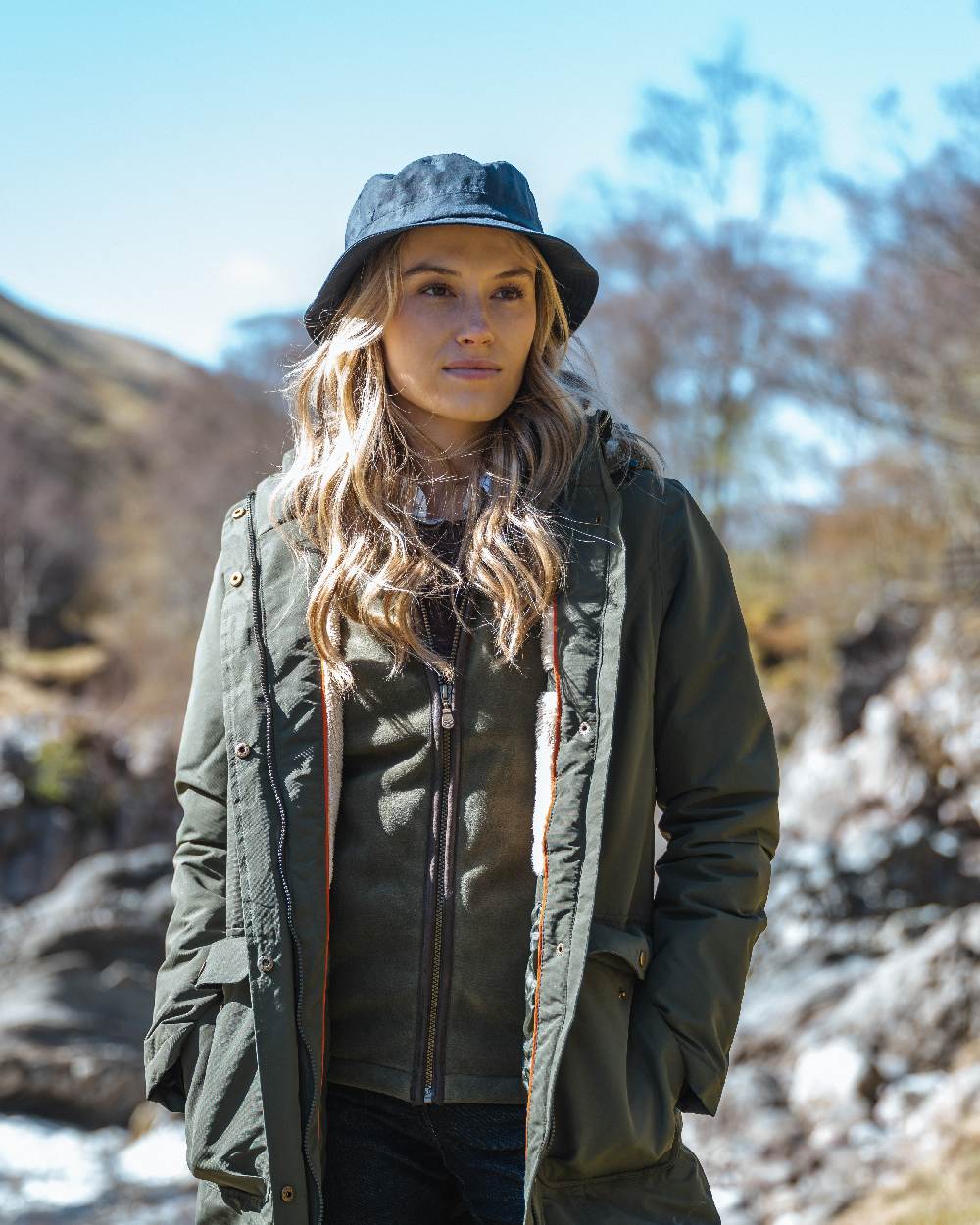 Green coloured Hoggs of Fife Womens Walker Long Coat on mountain background 