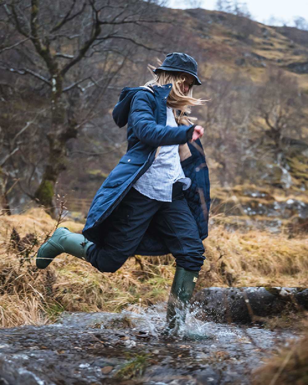Navy coloured Hoggs of Fife Womens Walker Long Coat on forest background 