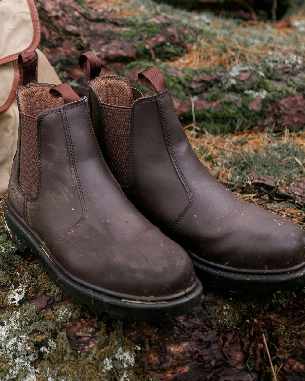 Dark Brown coloured Hoggs of Fife Classic Safety Dealer Boot on muddy background 