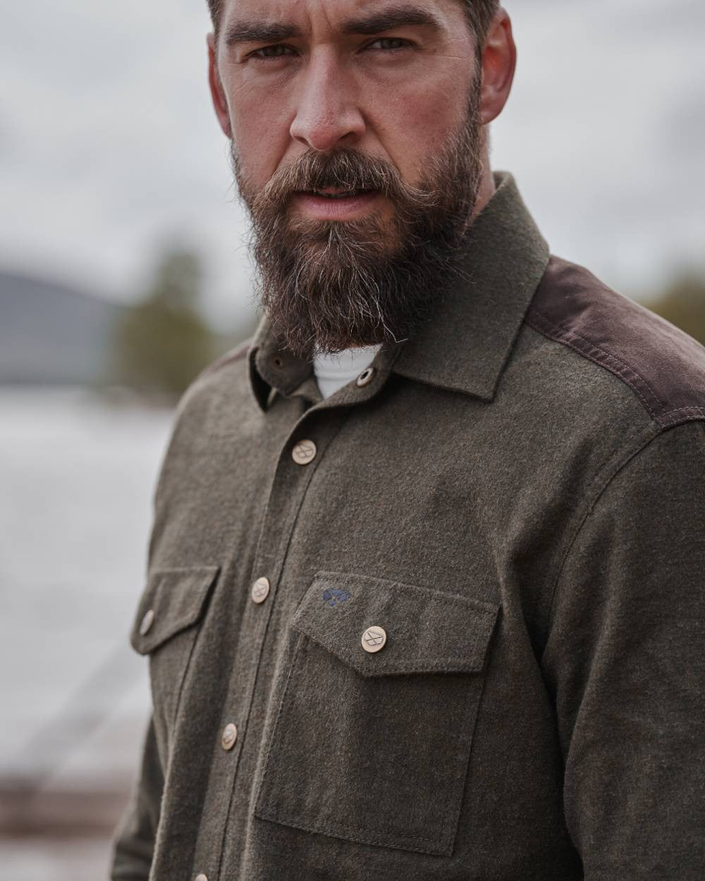 Loden Marl coloured Hoggs of Fife Dunvegan Flannel Shirt on blurry background 