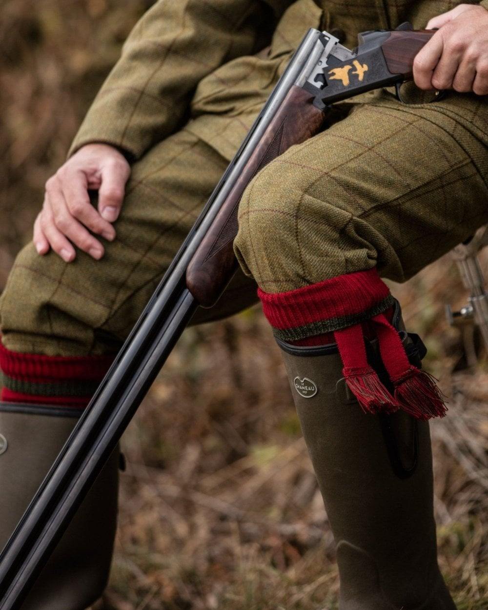 Brick Red Spruce coloured House of Cheviot Estate Field Socks on blurry background 