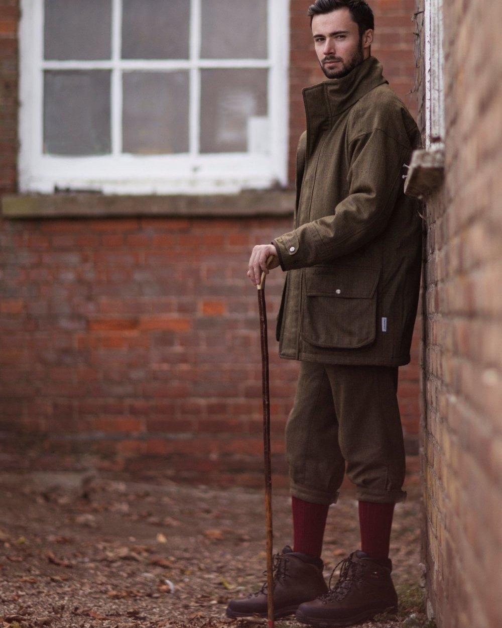 Brick Red coloured House of Cheviot Scarba Socks on wall background 