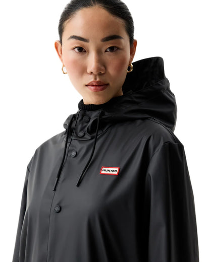 Black coloured Hunter Downpour Jo Pu Rain Parka on white background 