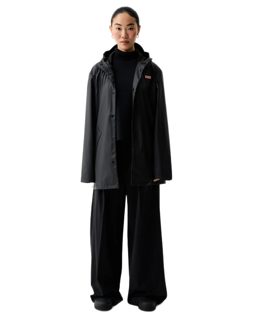 Black coloured Hunter Downpour Jo Pu Rain Parka on white background 