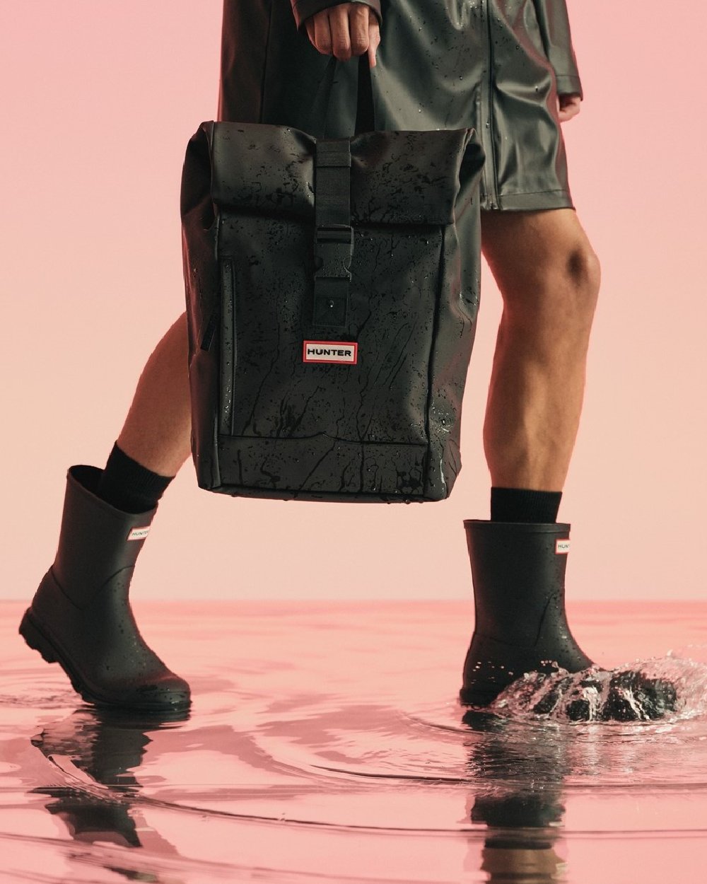 Black Coloured Hunter Mens Downpour Short Boots on water background 