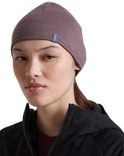 Dark Berry Grey Plum coloured Icebreaker 200 Oasis Reversible Beanie on white background 