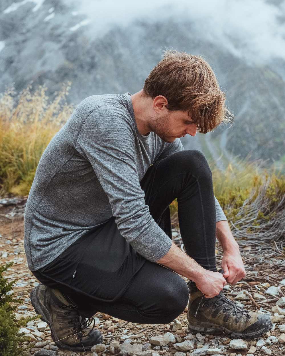 Gritstone Heather Coloured Icebreaker Mens Merino 200 Oasis Crewe Thermal Top on mountain background 