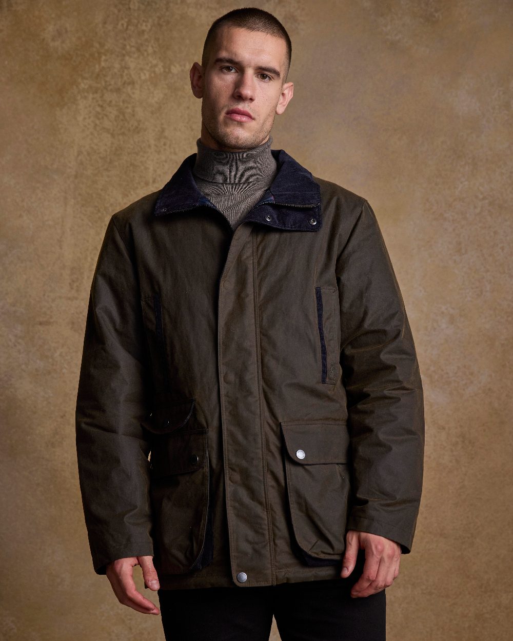 Olive Coloured Jack Murphy Archie Wax Jacket on indoor background 