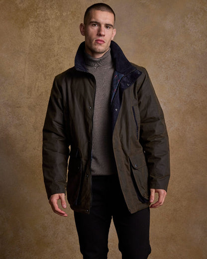 Olive Coloured Jack Murphy Archie Wax Jacket on indoor background 