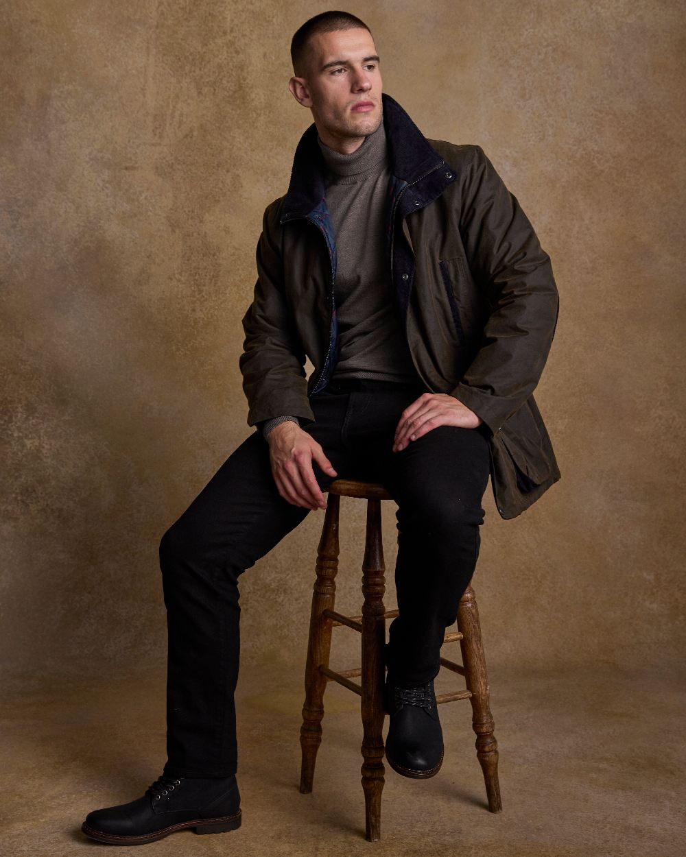 Olive Coloured Jack Murphy Archie Wax Jacket on indoor background 