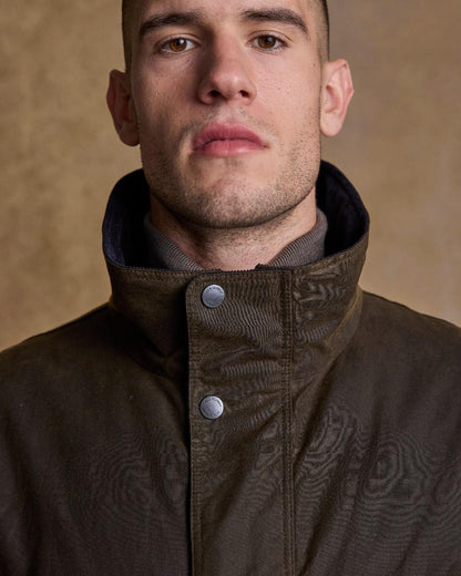 Olive Coloured Jack Murphy Archie Wax Jacket on indoor background 