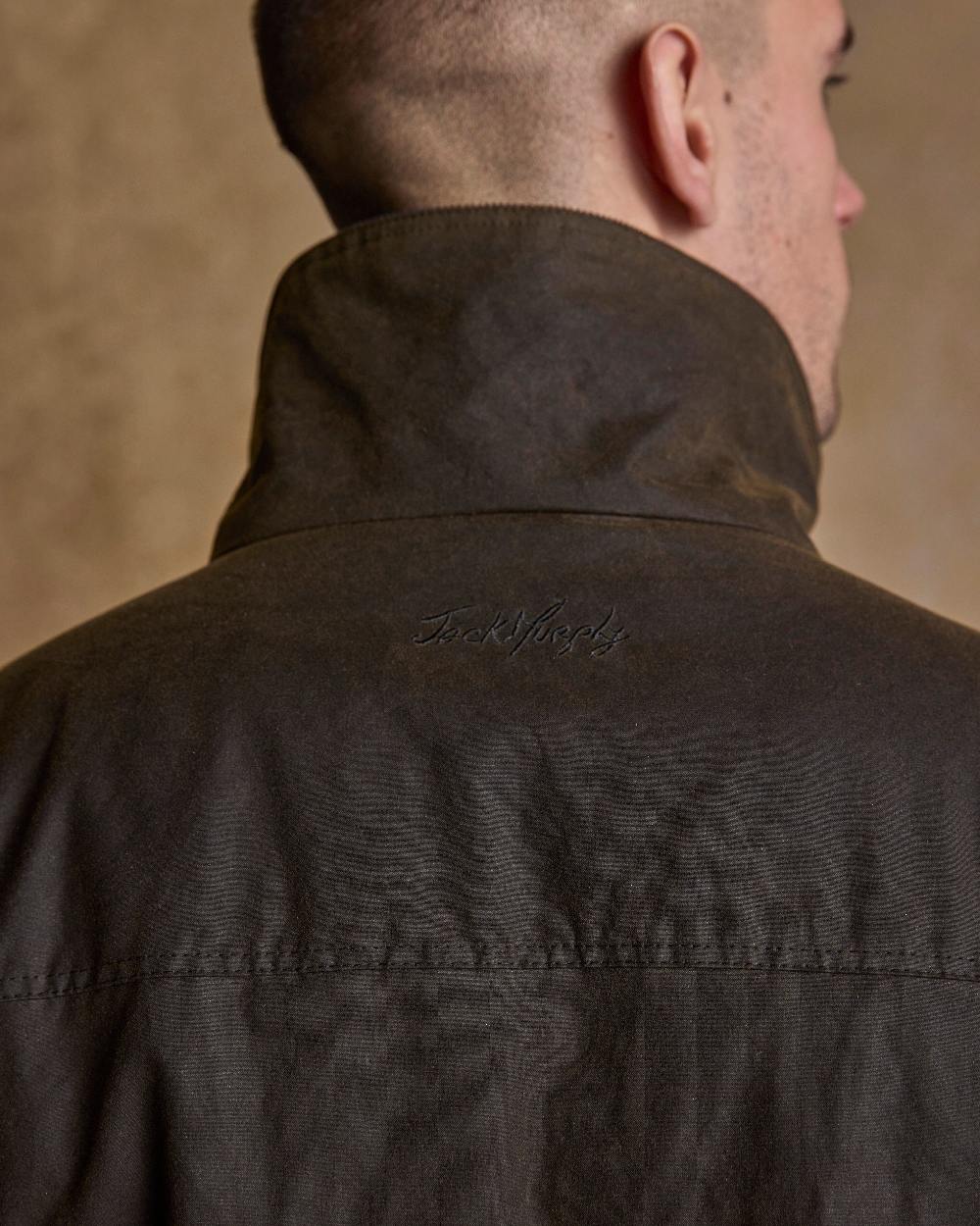 Olive Coloured Jack Murphy Archie Wax Jacket on indoor background 