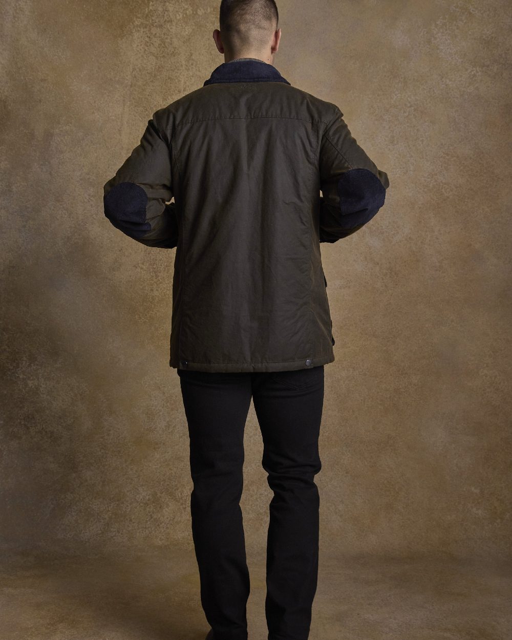 Olive Coloured Jack Murphy Archie Wax Jacket on indoor background 