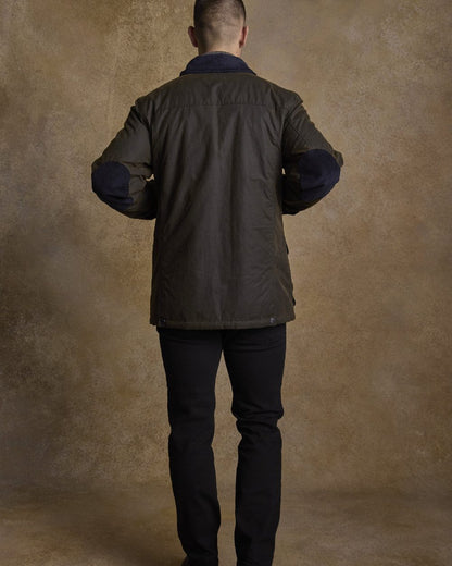 Olive Coloured Jack Murphy Archie Wax Jacket on indoor background 