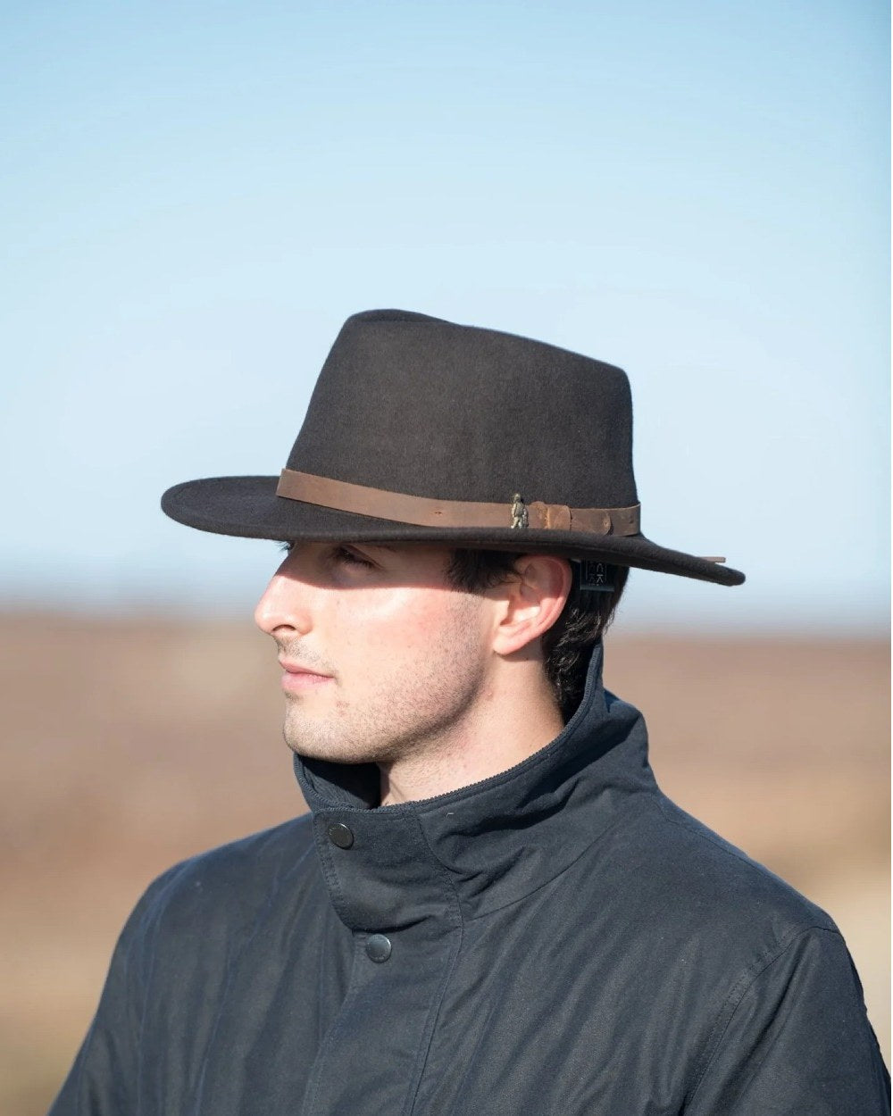 Brown coloured Jack Murphy Boston Crushable Felt Hat on sky background 