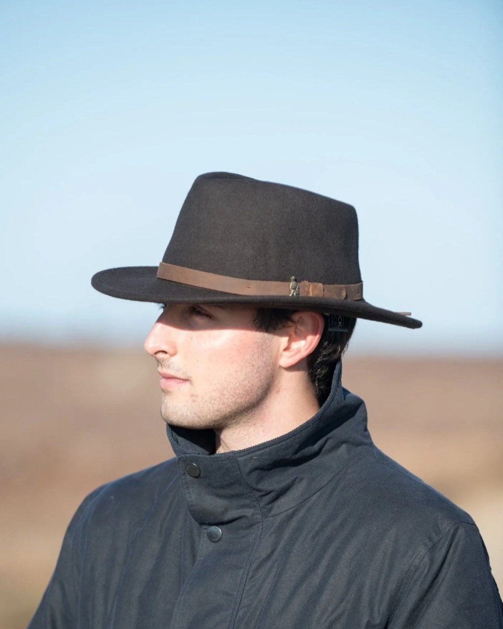 Brown coloured Jack Murphy Boston Crushable Felt Hat on sky background 