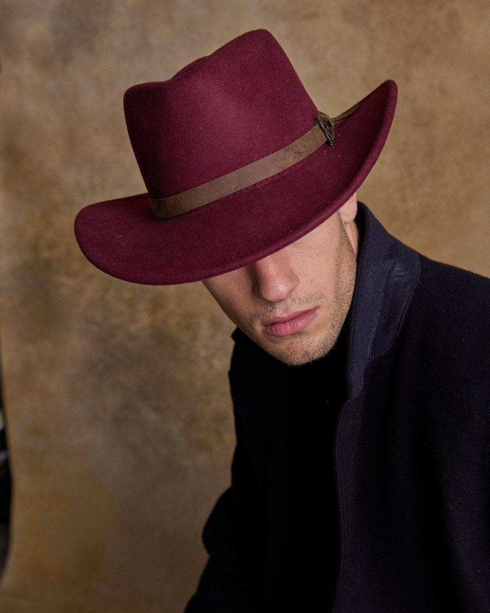 Burgundy Coloured Jack Murphy Boston Crushable Felt Hat on indoor background 