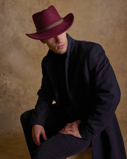 Burgundy Coloured Jack Murphy Boston Crushable Felt Hat on indoor background 