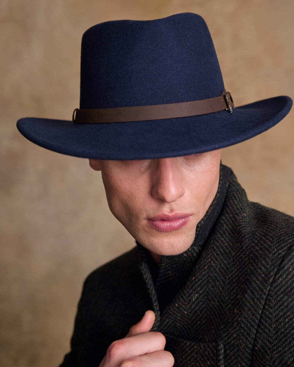 Navy Coloured Jack Murphy Boston Crushable Felt Hat on indoor background 