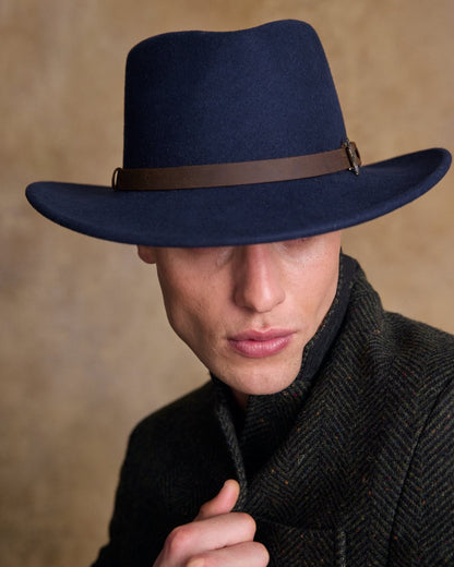 Navy Coloured Jack Murphy Boston Crushable Felt Hat on indoor background 