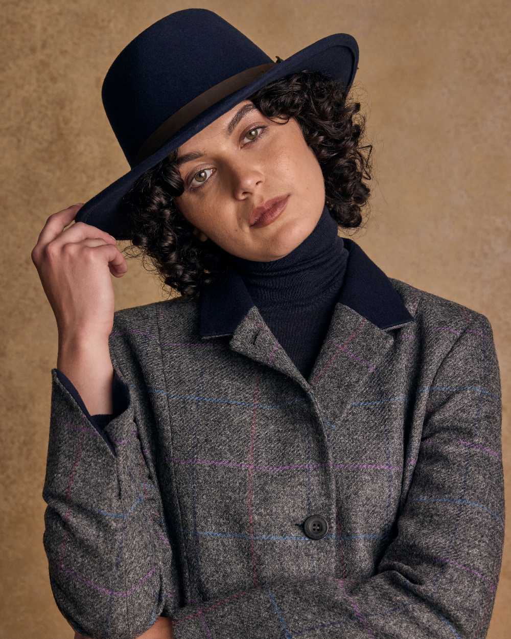 Navy Coloured Jack Murphy Boston Crushable Felt Hat on indoor background 
