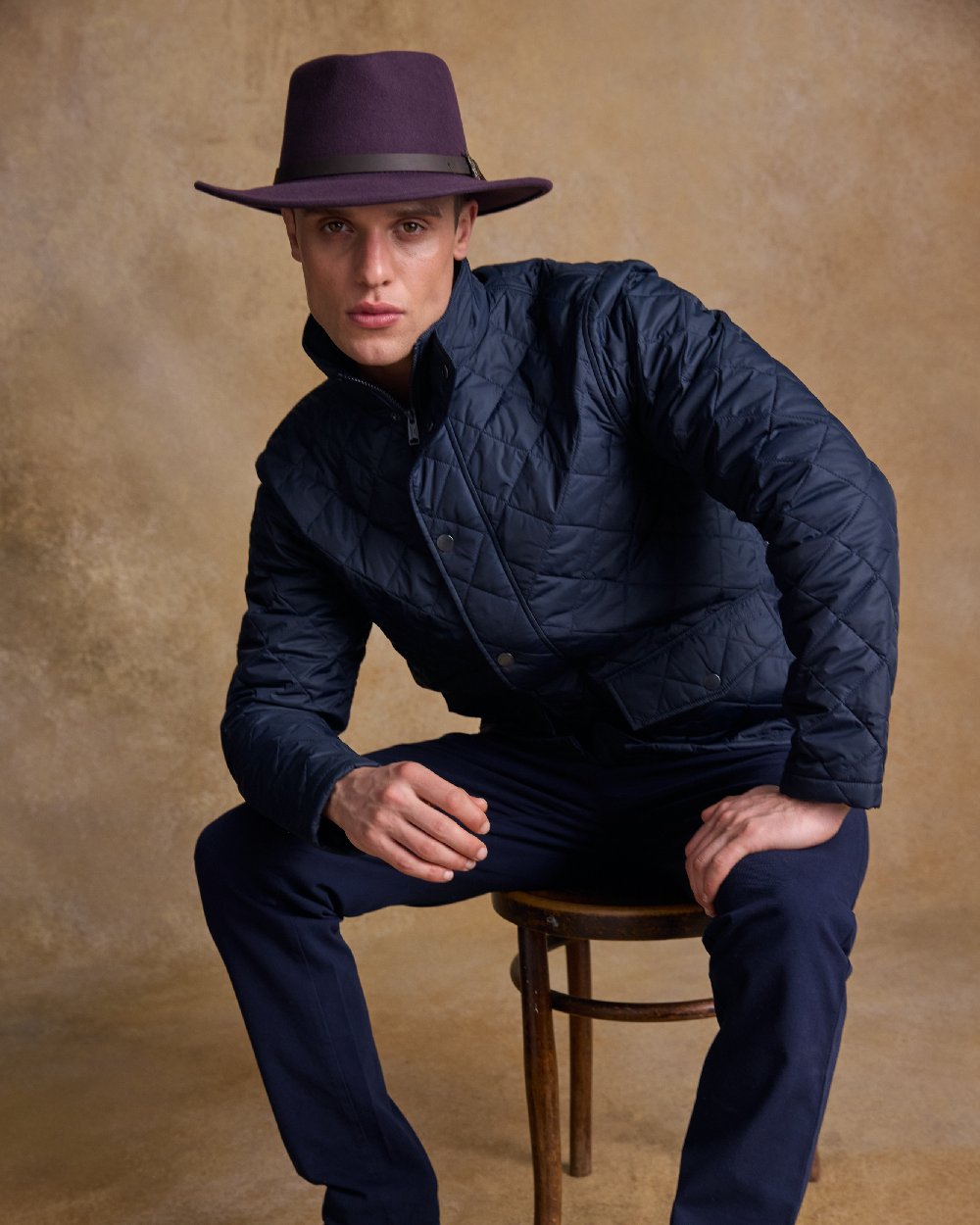 Plum Coloured Jack Murphy Boston Crushable Felt Hat on indoor background 