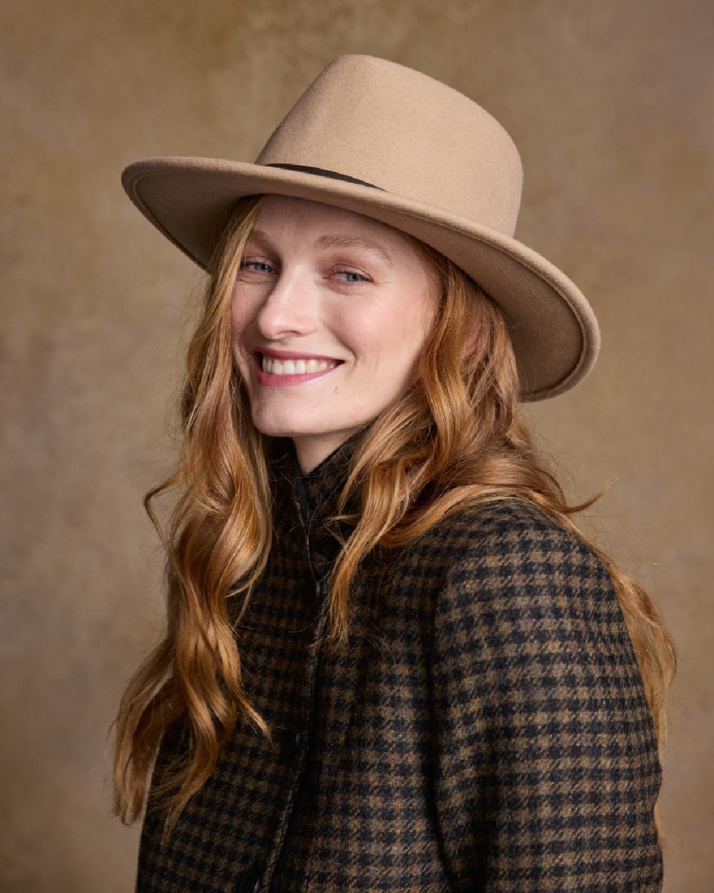 Tan Coloured Jack Murphy Boston Crushable Felt Hat on indoor background 