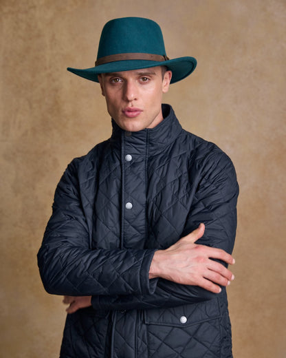 Teal Green Coloured Jack Murphy Boston Crushable Felt Hat on indoor background 