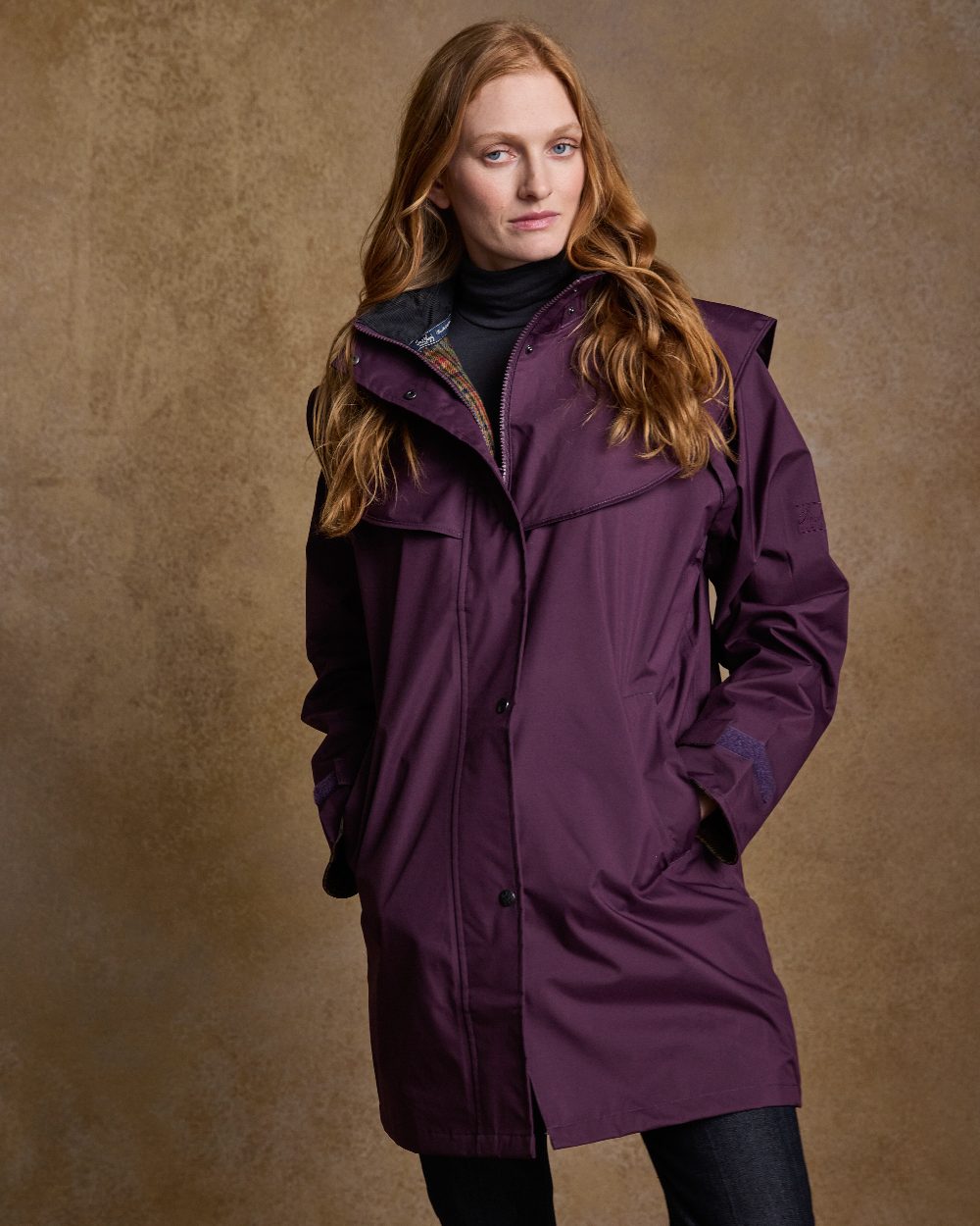 Blackberry Coloured Jack Murphy Cotswold Ladies Waterproof 3/4 Coat on indoor background 