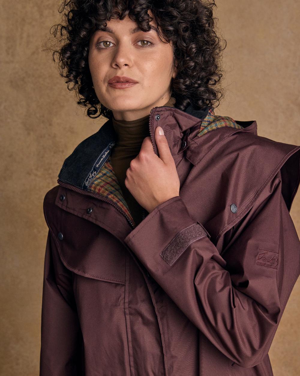Deep Claret Coloured Jack Murphy Cotswold Ladies Waterproof 3/4 Coat on indoor background 
