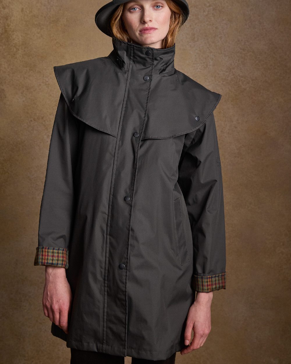 Olive Coloured Jack Murphy Cotswold Ladies Waterproof 3/4 Coat on indoor background 