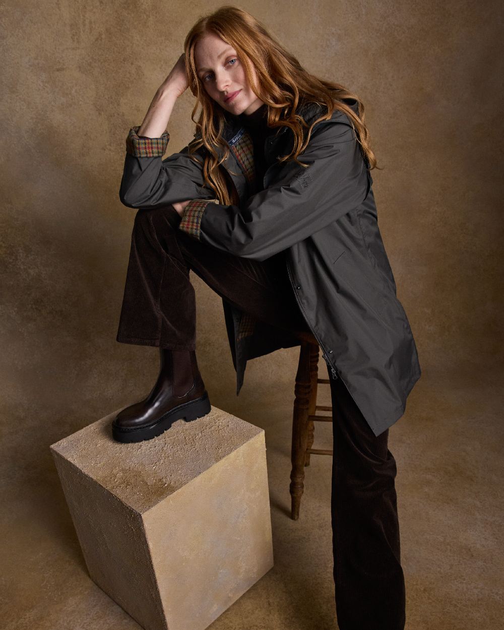 Olive Coloured Jack Murphy Cotswold Ladies Waterproof 3/4 Coat on indoor background 