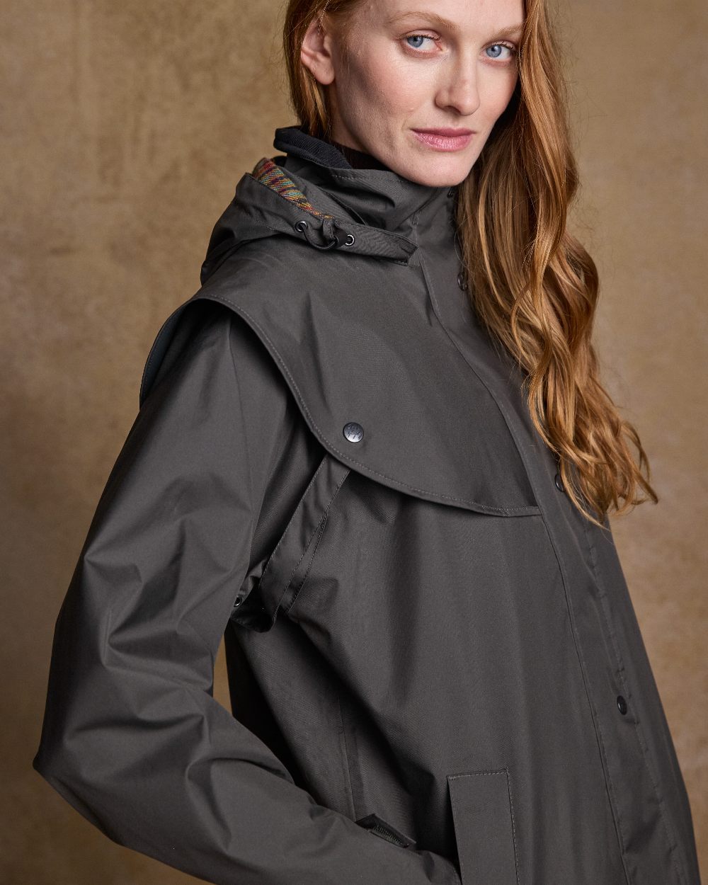 Olive Coloured Jack Murphy Cotswold Ladies Waterproof 3/4 Coat on indoor background 