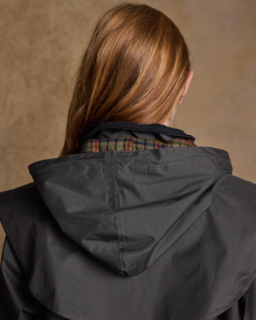 Olive Coloured Jack Murphy Cotswold Ladies Waterproof 3/4 Coat on indoor background 