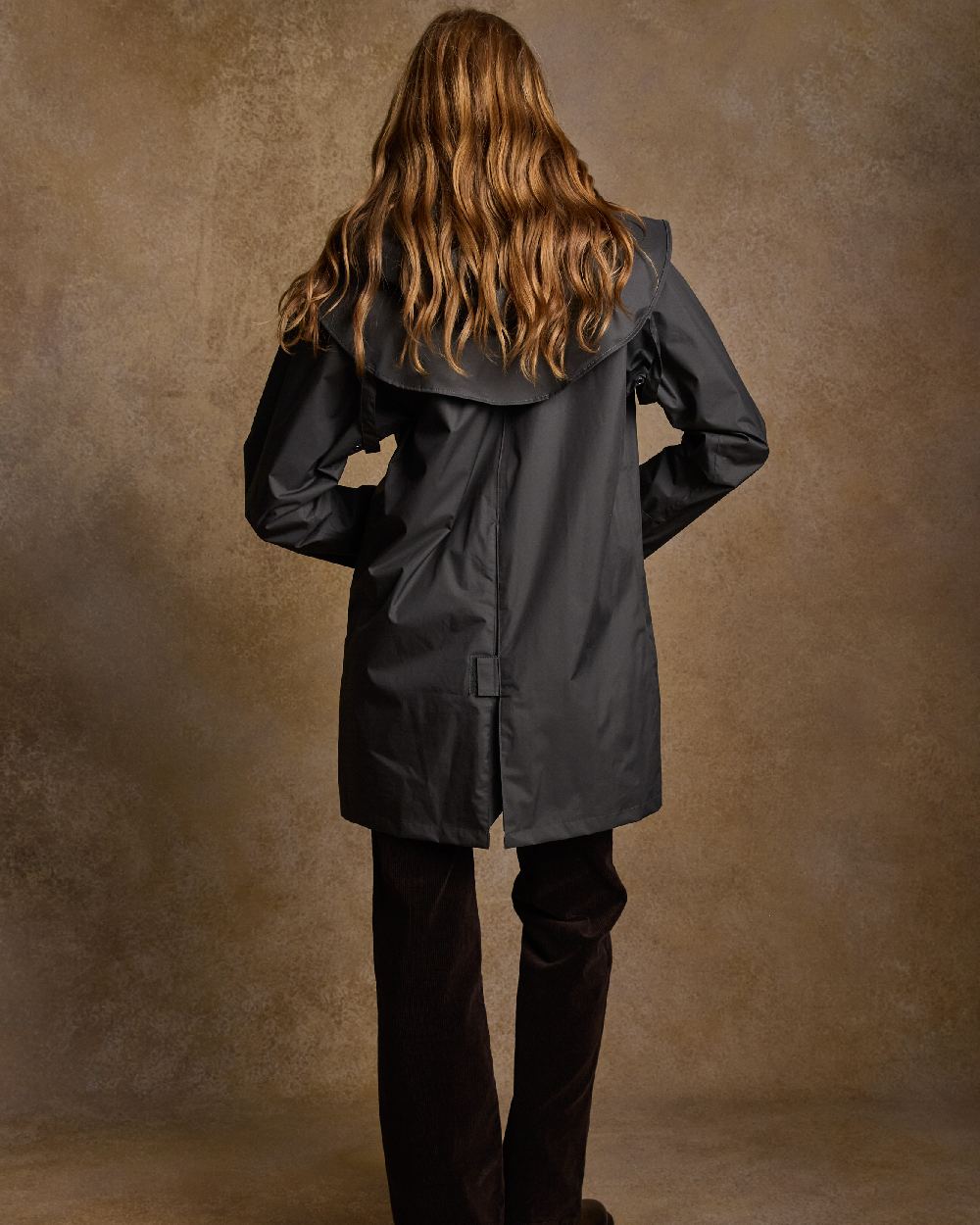 Olive Coloured Jack Murphy Cotswold Ladies Waterproof 3/4 Coat on indoor background 