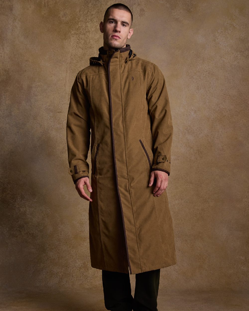 Camel Coloured Jack Murphy Emmet Waterproof Long Coat on indoor background 