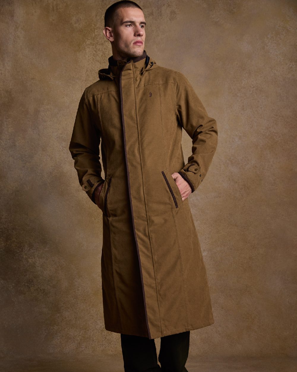 Camel Coloured Jack Murphy Emmet Waterproof Long Coat on indoor background 