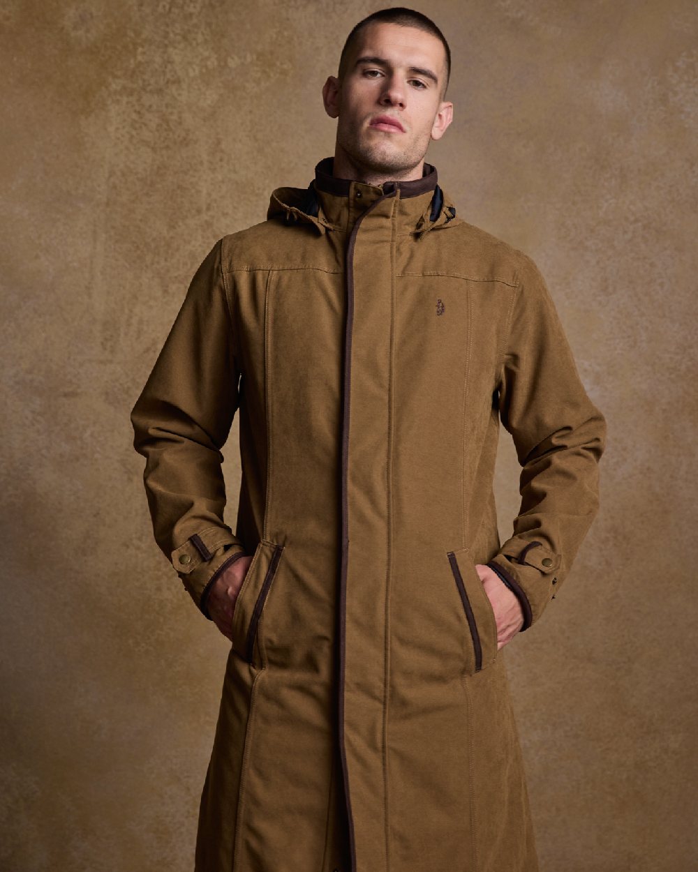 Camel Coloured Jack Murphy Emmet Waterproof Long Coat on indoor background 