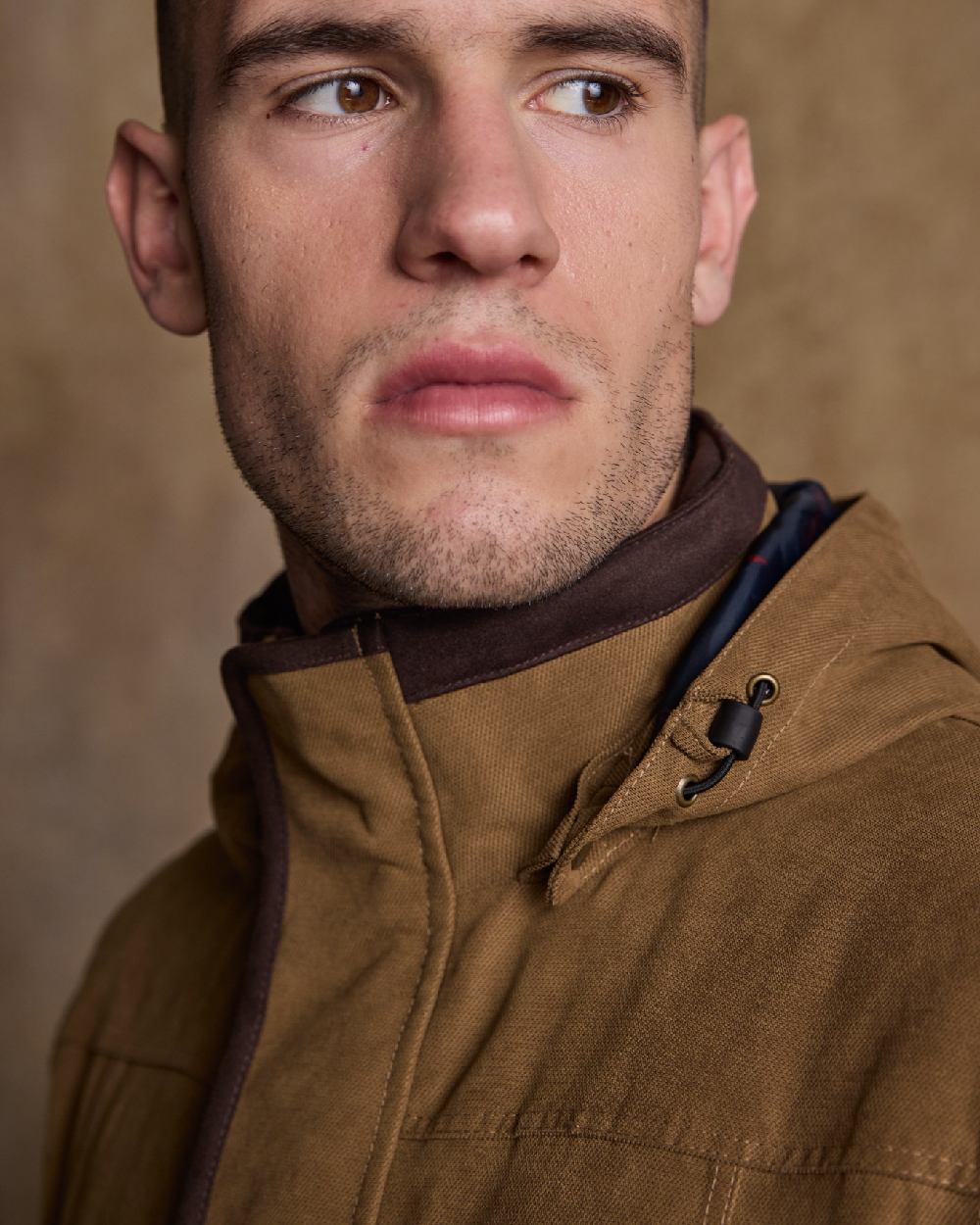 Camel Coloured Jack Murphy Emmet Waterproof Long Coat on indoor background 
