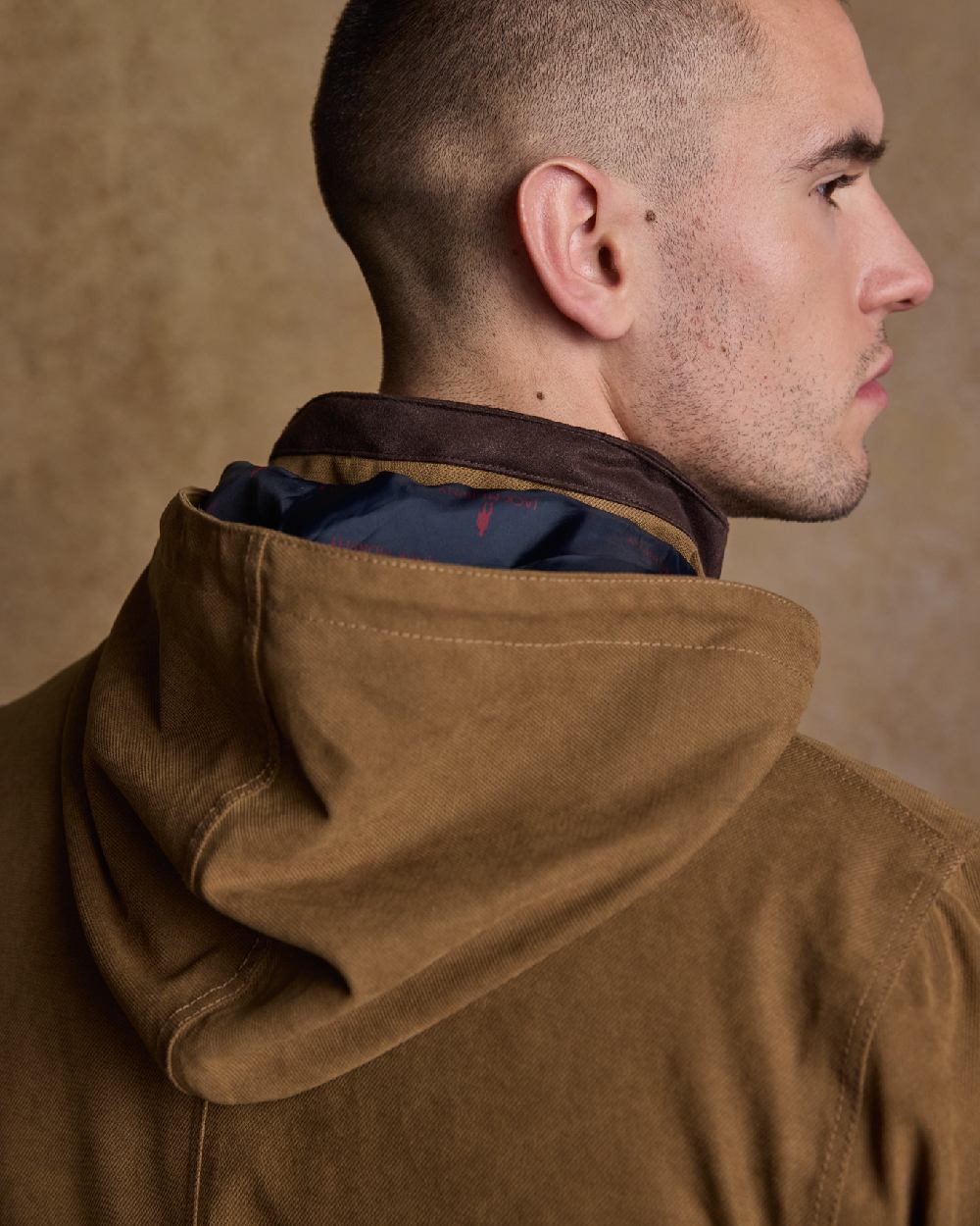 Camel Coloured Jack Murphy Emmet Waterproof Long Coat on indoor background 