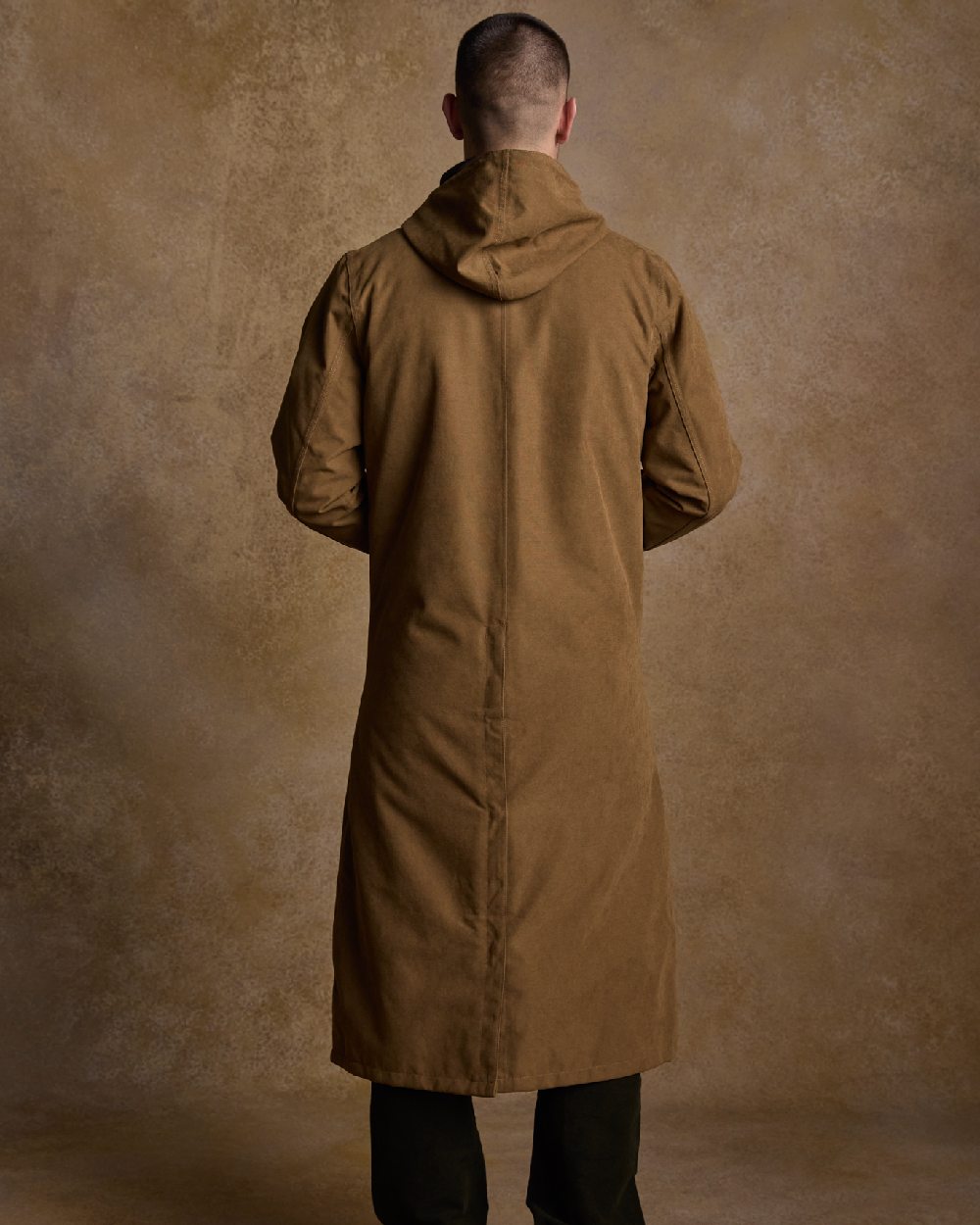 Camel Coloured Jack Murphy Emmet Waterproof Long Coat on indoor background 