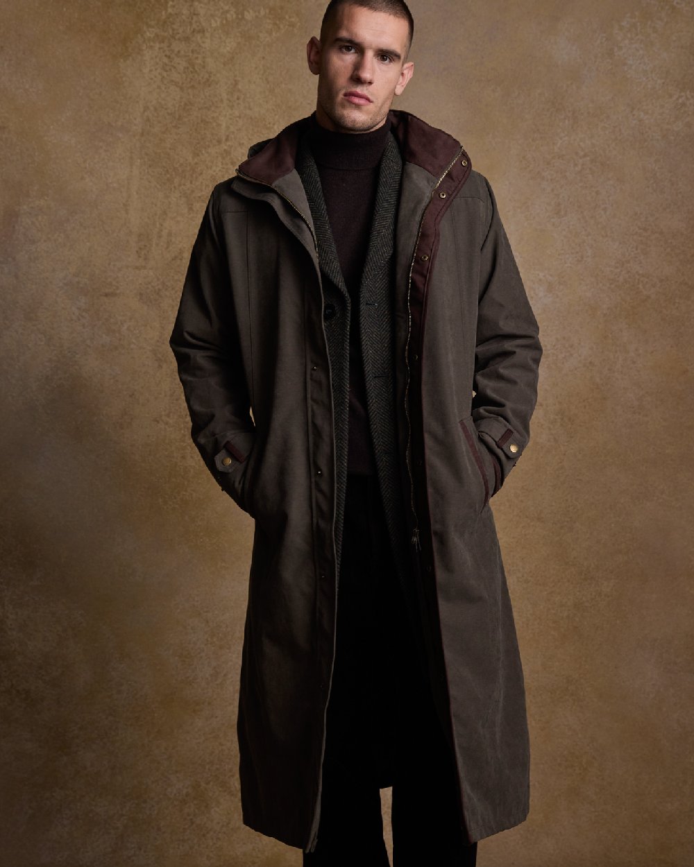 Olive Coloured Jack Murphy Emmet Waterproof Long Coat on indoor background 